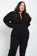 Woman wearing black comfy sweater and pants