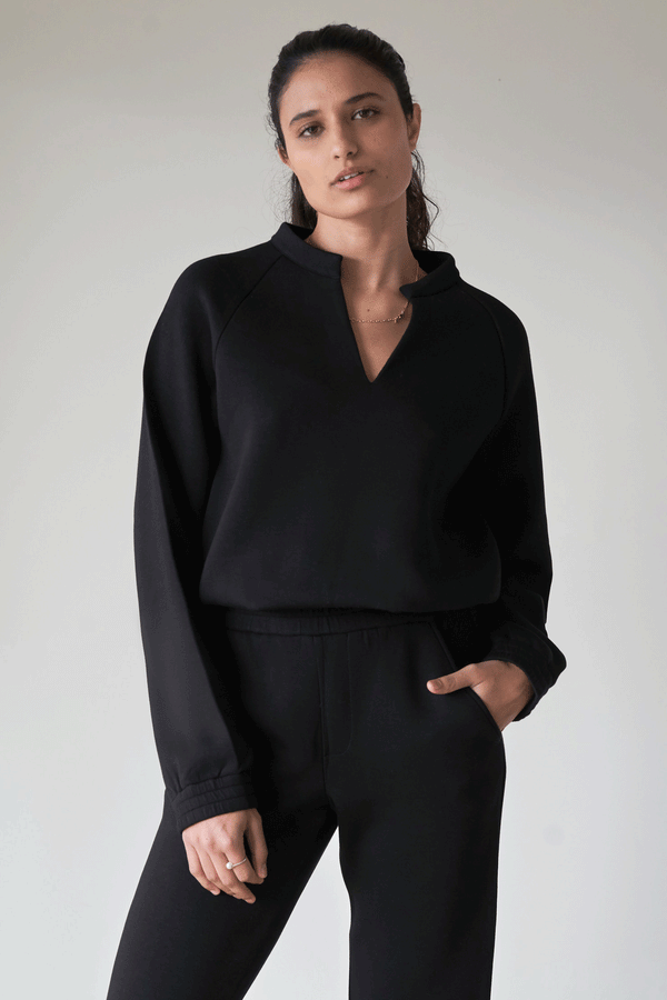 Woman wearing black comfy  v-neck sweater