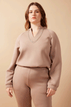 Woman wearing brown comfy sweater and pants