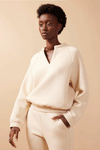 Woman wearing cream comfy sweater and pants